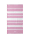 A rectangular pink beach towel with horizontal white stripes and a small white logo near the bottom, shown flat against a plain white background.
