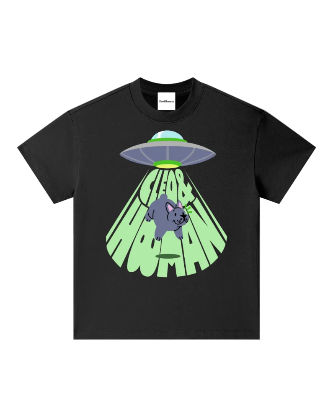 A black short-sleeve crewneck t-shirt featuring a cartoon graphic of a gray UFO casting a green beam of light that spells out 'Cleo&hooman' in a wavy font, with a cute gray cat hanging from the alien's tail.
