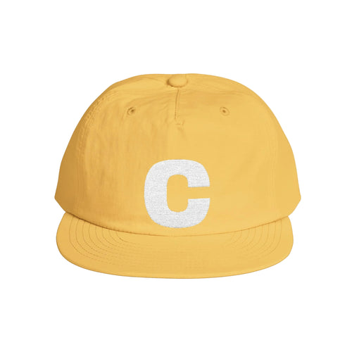 Yellow cap with white logo on a light gray background