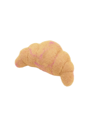 Croissant-shaped dog toy with pink stitching on a beige background