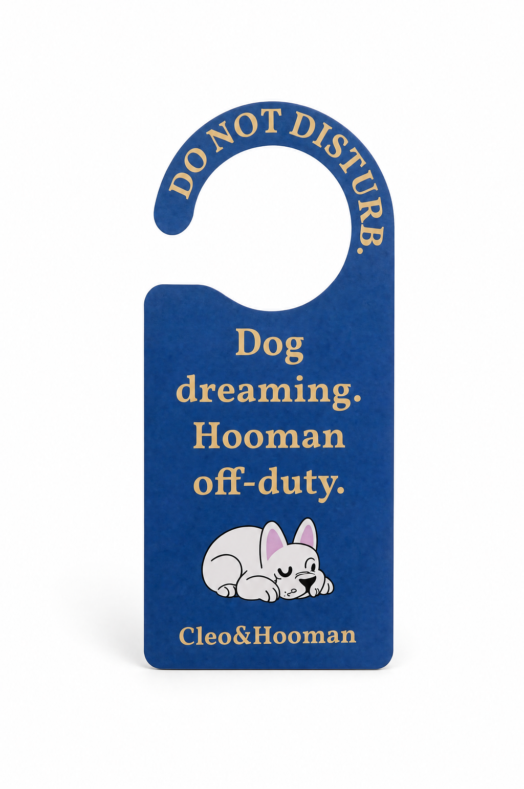A blue hanging door hanger sign with gold text reading 'DO NOT DISTURB.' at the top and 'Dog dreaming.