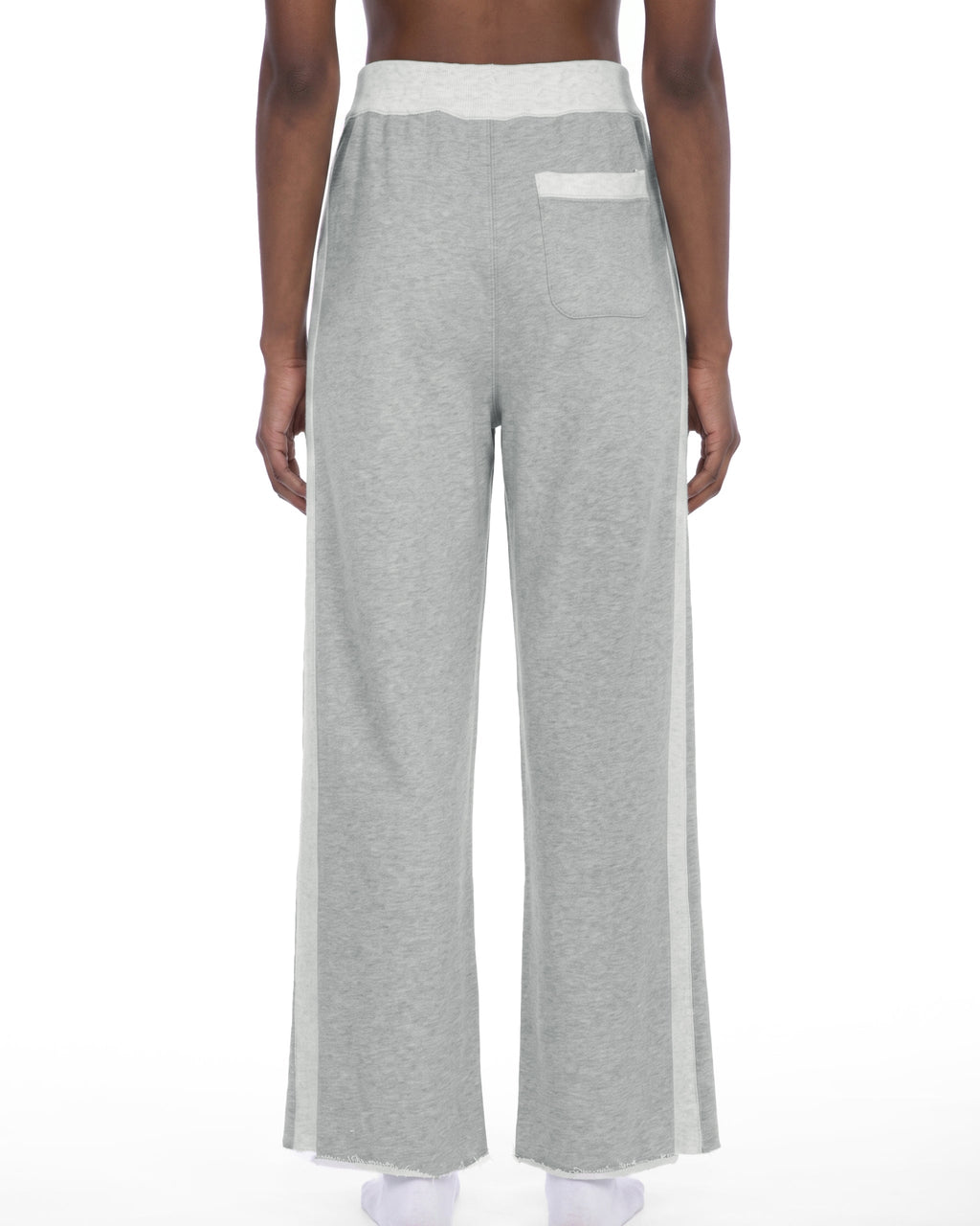 A person shown from the back wearing light heather gray wide-leg sweatpants with a white waistband, white side paneling, and a white back pocket, photographed against a plain white studio background.